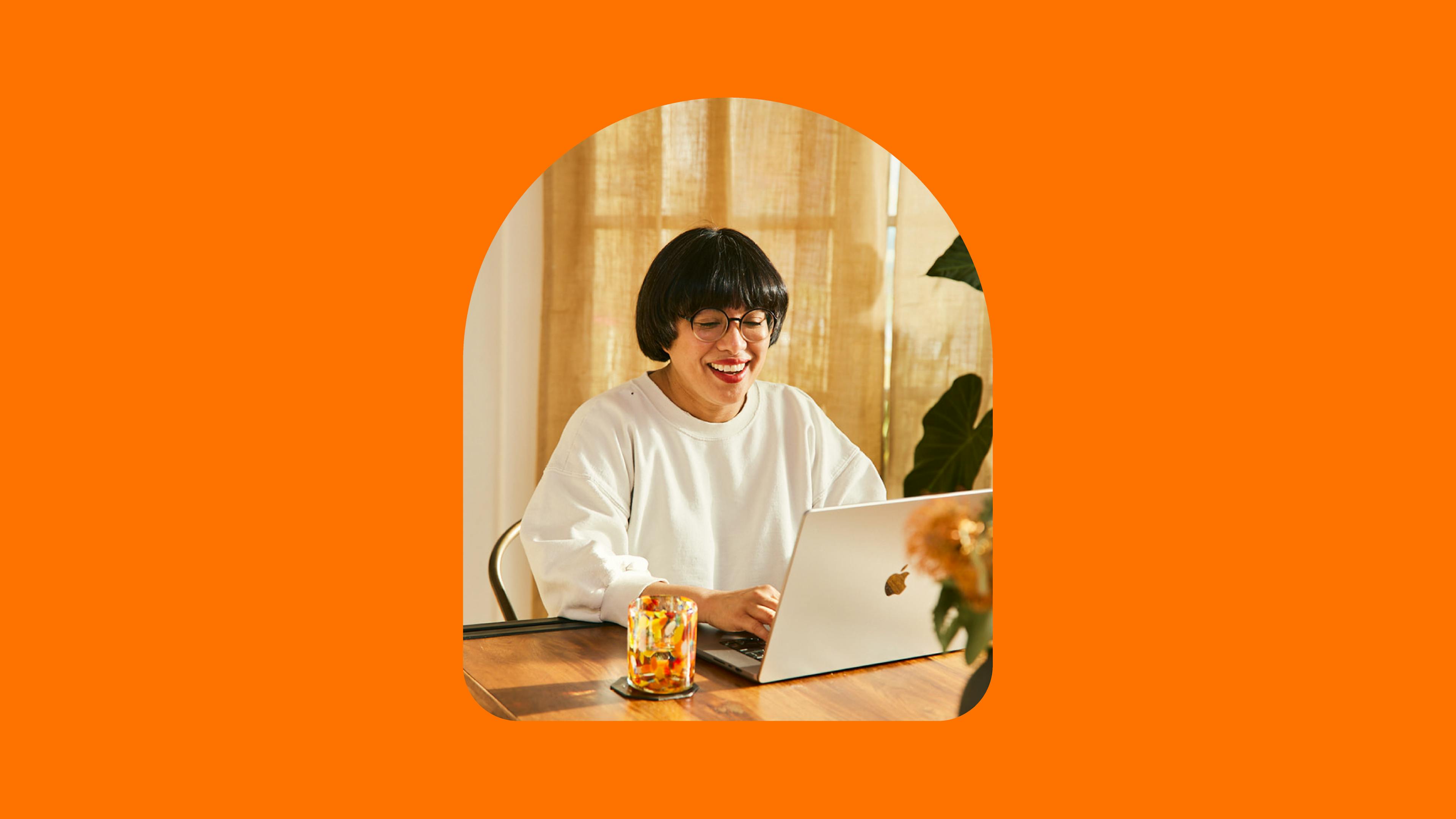 Woman smiling looking at laptop