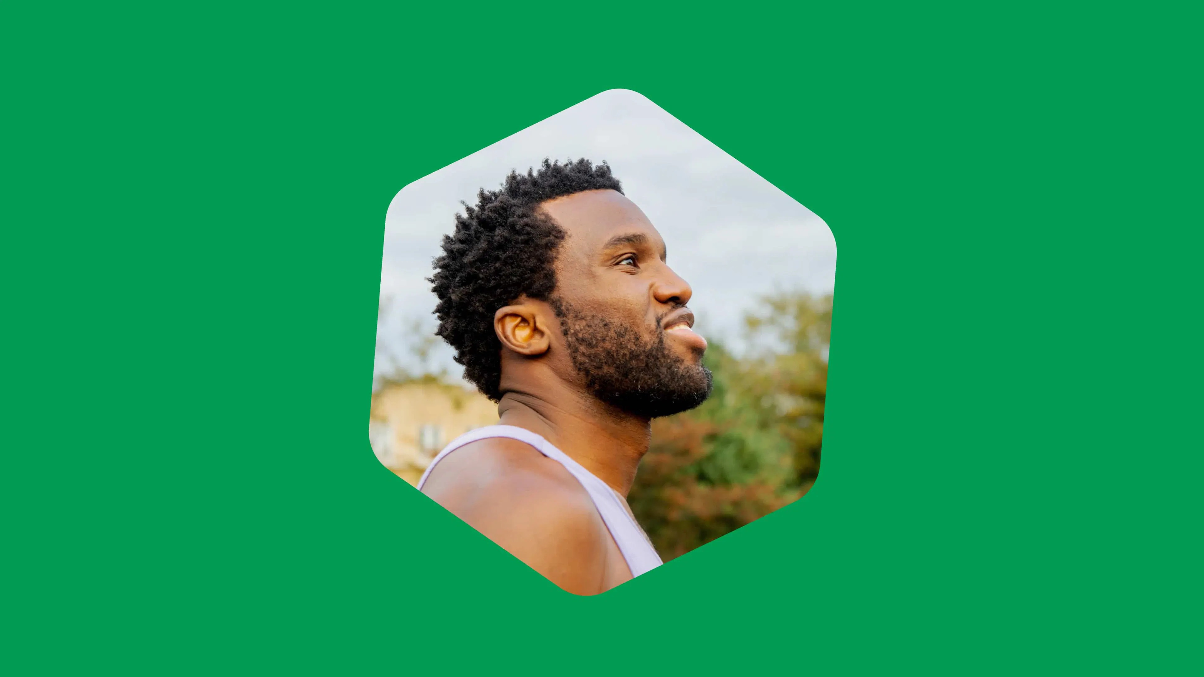 Man looking upward, framed in a hexagon on a green background.
